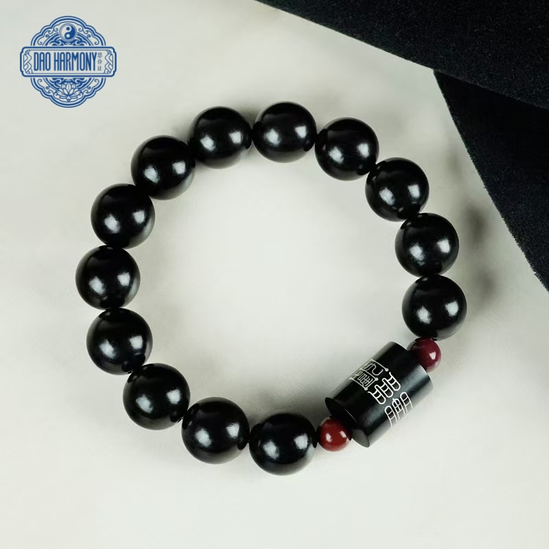 Ebony wood inlaid with silver inscriptions and blessing bracelets